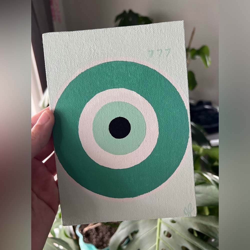 Teal evil eye 🧿 with angel number 777 for alignment